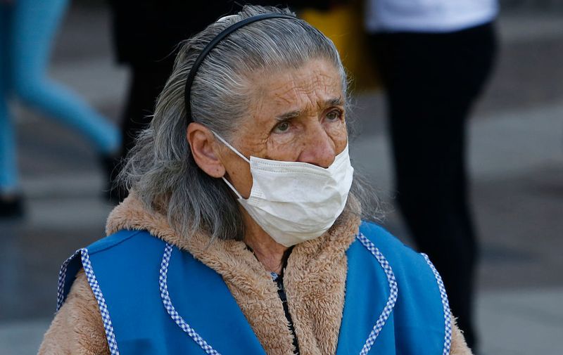 SANTIAGO, CHILE - MARCH 24: An elderly woman wears a face mask during the Covid-19 pandemic on March 24, 2020 in Santiago, Chile. The "state of catastrophe" declared by president Sebastian Piñera gives the government extraordinary powers to restrict freedom of movement and assure food supply and basic services for 90 days to confront the spread of COVID-19.  (Photo by Marcelo Hernandez/Getty Images)