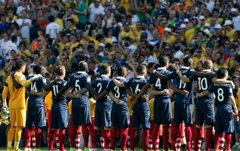 France's team line-up to sing their national anthem prior to the quarter-final football match between France and Germany at the Maracana Stadium in Rio de Janeiro during the 2014 FIFA World Cup on July 4, 2014. AFP PHOTO / ADRIAN DENNIS