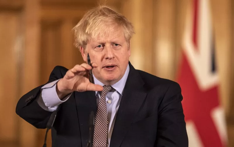 Prime Minister Boris Johnson gives a press conference on the ongoing COVID-19 situation in London on March 16, 2020. (Photo by Richard Pohle / POOL / AFP)