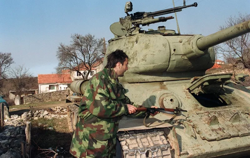 A Serbian soldier stands next to a Soviet-made T-34/76A Medium Tank dated from WWII, in Knin on February 03, 1993. UN cease-fire Between Croatians and Serbian forces was arranged on January  2, 1992. The UN Security Council in February approved sending a 14,000-member peace-keeping force to monitor the agreement and protect the minority Serbs in Croatia. In a 1993 referendum, the Serb-occupied portion of Croatia (Krajina) resoundingly voted for integration with Serbs in Bosnia and Serbia proper. Although the Zagreb government and representatives of Krajina signed a cease-fire in March 1994, further negotiations broke down. In a lightning-quick operation, the Croatian army retook western Slavonia in May 1995. Similarly, in August, the central Croatian region of Krajina, held by Serbs, was returned to Zagreb's control.   AFP PHOTO GABRIEL BOUYS (Photo by GABRIEL BOUYS / AFP)