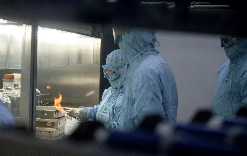 Researchers in protective suits work in a lab at the Yisheng Biopharma company, where researchers are trying to develop a vaccine for the COVID-19 coronavirus, in Shenyang, in Chinas northeast Liaoning province, on June 9, 2020. - China has mobilised its army and fast-tracked tests in the global race to find a coronavirus vaccine, and is involved in several of the dozen or so international clinical trials currently under way. (Photo by NOEL CELIS / AFP)