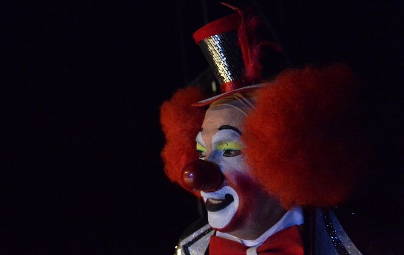 A clown remains on the stage during the second day of the XXI Convention of Clowns, at the Jimenez Rueda Theatre, in Mexico City on October 18, 2016. 
Latin American clowns hold their 21st annual conference in Mexico City from October 17 through 20. The lurking clown phenomenon as a wave of hysteria about sightings of "creepy" or "killer" clowns that sweeps the United States and European nations will be discussed. / AFP PHOTO / PEDRO PARDO