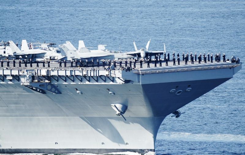 This photograph taken on May 24, 2023 shows the US aircraft carrier USS Gerald R. Ford cruising near Jeloya island, in Moss, south of Oslo. The ship is the world's largest warship and will be in port in Oslo for four days. Russia's embassy in Norway on Tuesday, May 23, 2023 hashly criticised the visit by the US aircraft carrier to Oslo as an "illogical and harmful" show of force. (Photo by Terje Pedersen / NTB / AFP) / Norway OUT