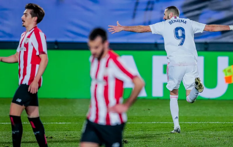 Real Madrid's Karim Benzema, right, celebrates after scoring his side's third goal during the Spanish La Liga soccer match between Real Madrid and Athletic Club Bilbao at the Alfredo Di Stefano stadium in Madrid, Spain, Tuesday, Dec. 15, 2020. (AP Photo/Bernat Armangue)