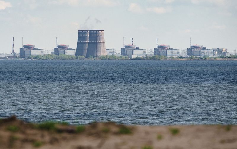 A general view shows the Zaporizhzhia nuclear power plant, situated in the Russian-controlled area of Enerhodar, seen from Nikopol in April 27, 2022. (Photo by Ed JONES / AFP)