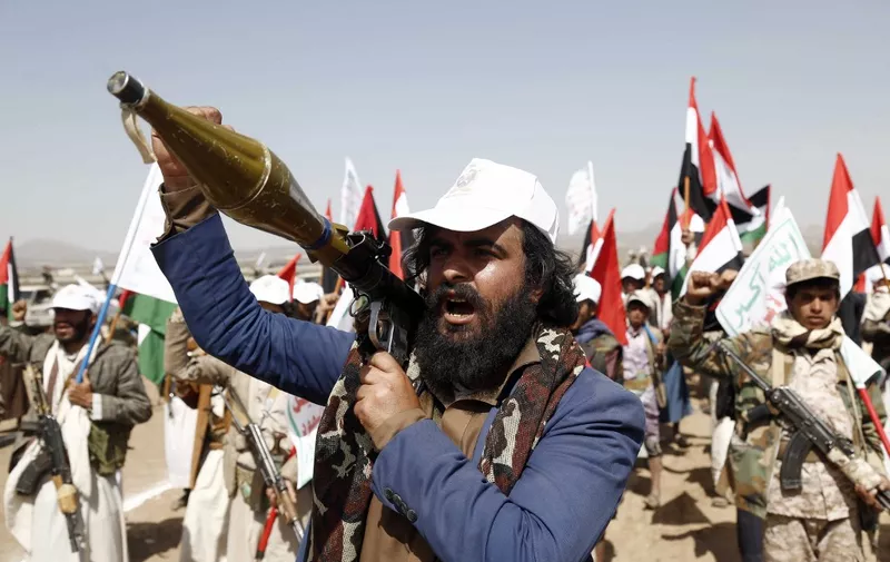 SANAA, YEMEN - FEBRUARY 4: A man carries a weapon as people attend a graduation ceremony for cadet, completed their military training under the name of 'Aqsa Flood', organized by the Houthis, in Arhab district of Sana'a, Yemen on February 4, 2024. Mohammed Hamoud / Anadolu (Photo by Mohammed Hamoud / ANADOLU / Anadolu via AFP)