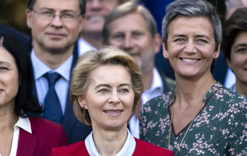 European Commission President Ursula von der Leyen looks on as she pose for a photo family during a seminar in Genval on September 12, 2019. (Photo by Kenzo TRIBOUILLARD / AFP)