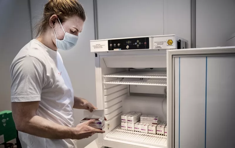 Medical personnel takes AstraZeneca vaccines out of the freezer at the Region Hovedstaden's vaccine center in Bella Center in Copenhagen on February 11, 2021, amid the ongoing coronavirus Covid-19 pandemic. (Photo by Liselotte Sabroe / Ritzau Scanpix / AFP) / Denmark OUT