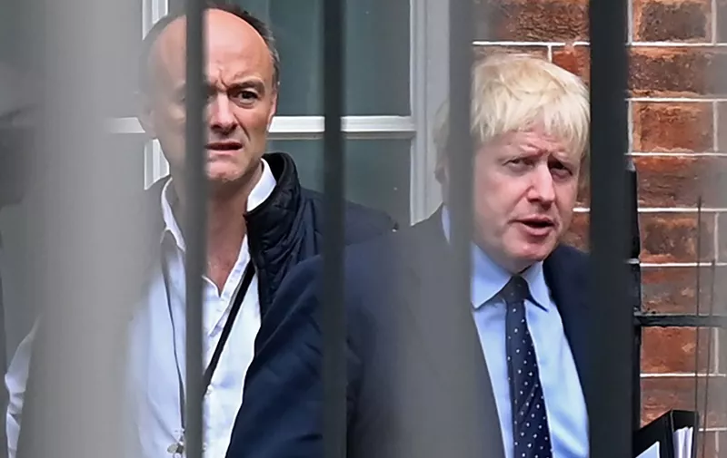 (FILES) In this file photo taken on September 03, 2019 Britain's Prime Minister Boris Johnson (R) and his special advisor Dominic Cummings leave from the rear of Downing Street in central London, before heading to the Houses of Parliament. - One of British Prime Minister Boris Johnson's top advisers, Dominic Cummings, drew police attention after allegedly breaking the coronavirus lockdown, reports said on May 22. Cummings left his London home to stay with his parents in Durham, northeast England, while suffering symptoms of COVID-19, the Daily Mirror and The Guardian newspapers said. (Photo by DANIEL LEAL-OLIVAS / AFP)