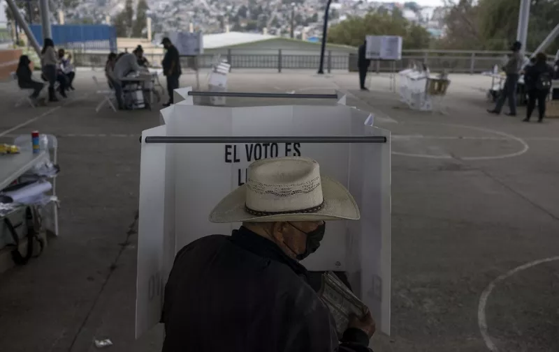 A man casts his vote at a polling station during midterm elections in Tijuana, Mexico, on June 6, 2021. - Mexicans began voting Sunday in elections seen as pivotal to President Andres Manuel Lopez Obrador's promised "transformation" of a country shaken by the coronavirus pandemic, a deep recession and drug-related violence. (Photo by Guillermo Arias / AFP)