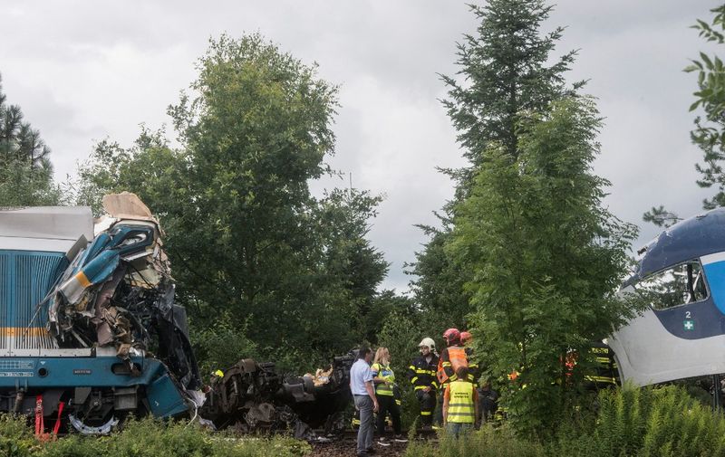 Rescue teams work around two collided trains near the village of Milavce between the stations Domazlice and Blizejovn, Czech Republic, on August 4, 2021. - Three people died and dozens more were injured when the Munich-to-Prague train, number Ex 351 belonging to the German firm Die Laenderbahn, collided with a regional service, according to railway officials. (Photo by Michal CIZEK / AFP)