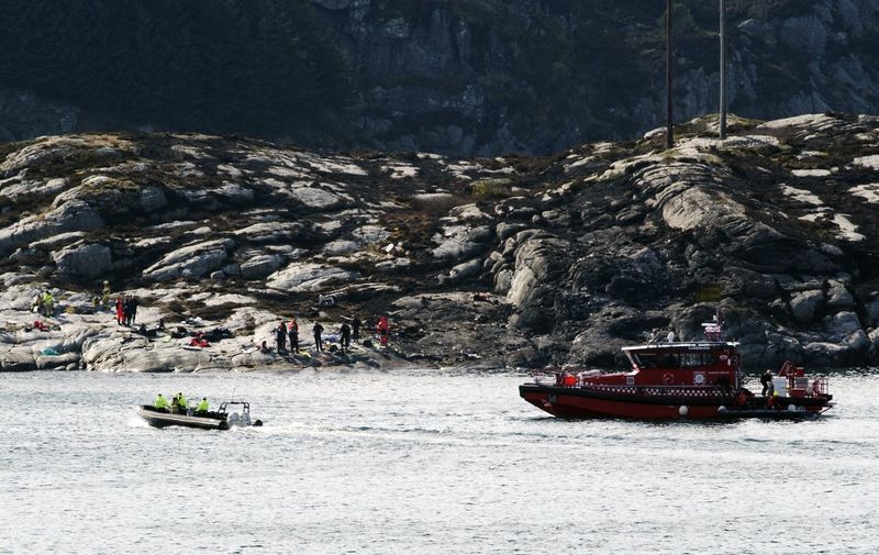 Rescue forces work at the shore west of Bergen, Norway after a helicopter transporting 13 workers from an offshore oil field in the North Sea crashed off on April 29, 2016. - All 13 people on board a helicopter that crashed off the coast of western Norway died in the accident, rescue services said. (Photo by Marit Hommedal / various sources / AFP) / Norway OUT
