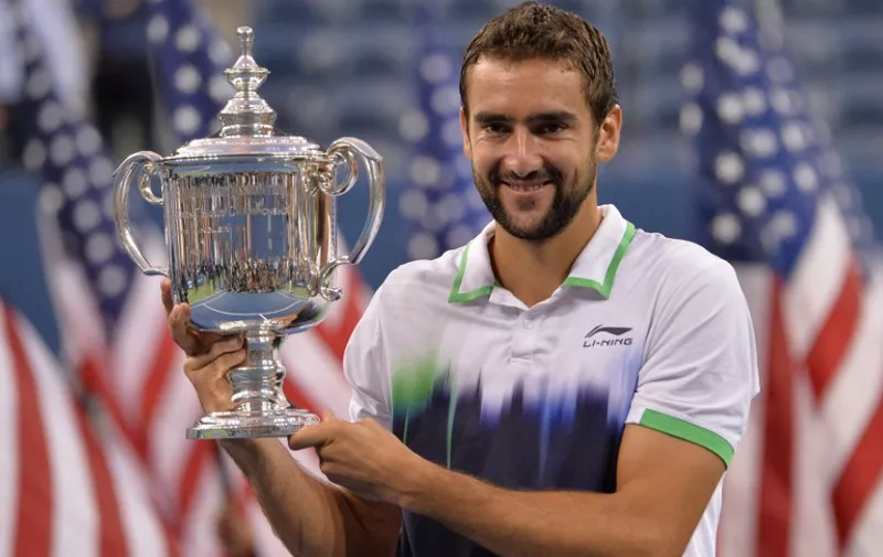 Marin Cilic of Croatia holds the US Open trophy after defeating Kei Nishikori of Japan during their US Open 2014 men's singles finals match at the USTA Billie Jean King National Center September 8, 2014  in New York. AFP PHOTO/Stan Honda
