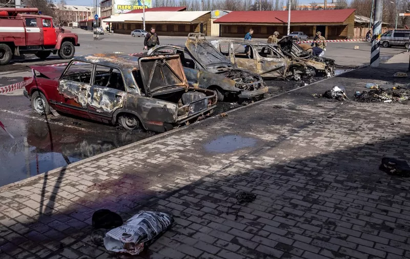 Calcinated cars are pictured outside a train station in Kramatorsk, eastern Ukraine, that was being used for civilian evacuations, after it was hit by a rocket attack killing at least 35 people, on April 8, 2022. (Photo by FADEL SENNA / AFP)