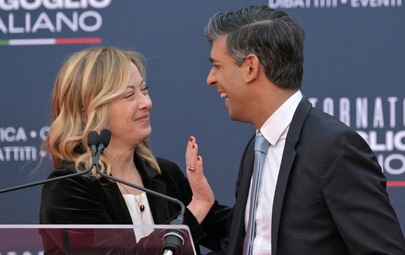 British Prime Minister Rishi Sunak jokes with Italian Prime Minister Giorgia Meloni during the Atreju political meeting organised by the young militants of Italian right wing party Brothers of Italy (Fratelli d'Italia) on December 16, 2023 at the Sant'Angelo castle in Rome. (Photo by Andreas SOLARO / AFP)