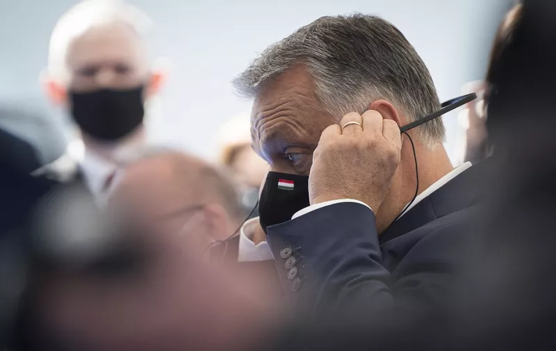 Hungarian Prime Minister Viktor Orban adjusts his headphones as he attends the opening ceremony for the start of works to build the electric power line Cirkovce-Pince start, in Kidricevo, Slovenia on October 14, 2020. (Photo by Jure Makovec / AFP)