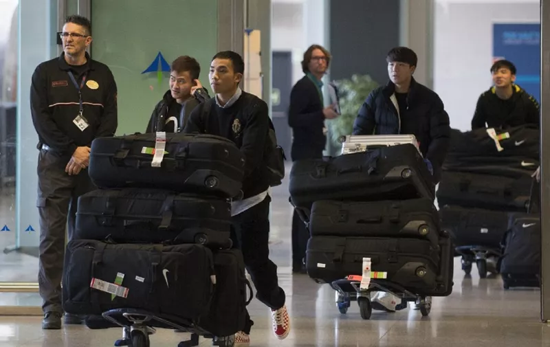 Members of Wuhan Zall FC Chinese football team arrive at the Malaga's Costa del Sol Airport on January 29, 2020. (Photo by JORGE GUERRERO / AFP)
