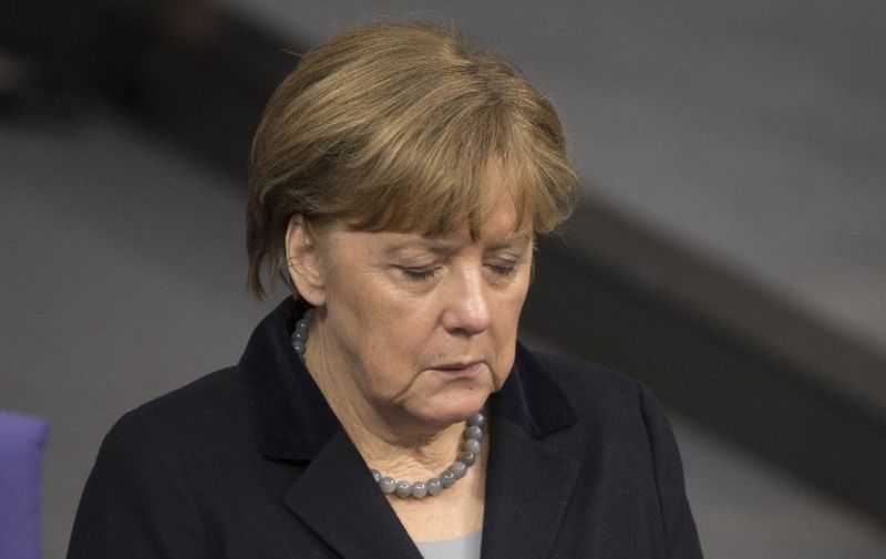 German Chancellor Angela Merkel closes her eyes as delegates pay respect to the victims of the suicide attack in Istanbul at the beginning of a session of the Bundestag (lower house of parliament) in Berlin on January 13, 2016.
Ten German citizens were killed in an attack that was carried out on January 12, 2016 by a Syrian suicide bomber who blew himself up in Istanbul's busiest tourist district. / AFP / AXEL SCHMIDT