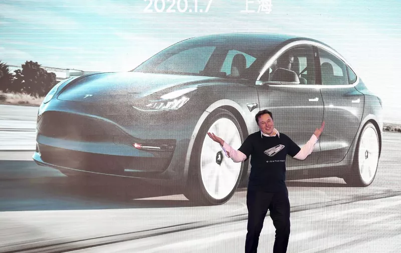 Tesla CEO Elon Musk gestures during the Tesla China-made Model 3 Delivery Ceremony in Shanghai. - Tesla CEO Elon Musk presented the first batch of made-in-China cars to ordinary buyers on January 7, 2020 in a milestone for the company's new Shanghai "giga-factory", but which comes as sales decelerate in the world's largest electric-vehicle market. (Photo by STR / AFP) / China OUT