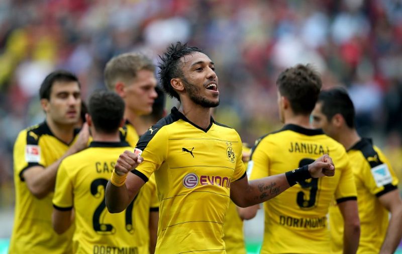 Dortmund's Gabonese striker Pierre-Emerick Aubameyang (C) celebrates after scoring his team's fourth goal during the German first division Bundesliga football match Hannover 96 v Borussia Dortmund, in Hannover, on September 12, 2015.  AFP PHOTO /  RONNY HARTMANN

RESTRICTIONS: DURING MATCH TIME: DFL RULES TO LIMIT THE ONLINE USAGE TO 15 PICTURES PER MATCH AND FORBID IMAGE SEQUENCES TO SIMULATE VIDEO. 
== RESTRICTED TO EDITORIAL USE ==
FOR FURTHER QUERIES PLEASE CONTACT DFL DIRECTLY AT + 49 69 650050.