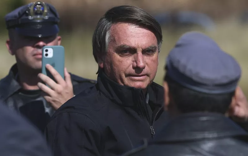 (FILES) Brazil's President Jair Bolsonaro arrives to meet CEO, and chief engineer at SpaceX, Elon Musk, at the event Conecta Amazonia in Porto Feliz, Sao Paulo state, Brazil on May 20, 2022. Police in Brazil have recommended prosecuting Brazilian former president Jair Bolsonaro for falsifying vaccination certificates against COVID-19, including his own and his daughter's, in a case that increases judicial pressure against the former leader. Bolsonaro and 16 others were implicated in a scheme to issue "ideologically false certificates, with the intention of obtaining undue advantages related to the circumvention of sanitary measures" during the pandemic, according to the Federal Police document released on March 19, 2024. The former president, who always played down COVID-19, publicly acknowledged that he did not get vaccinated. (Photo by Filipe ARAUJO / AFP)