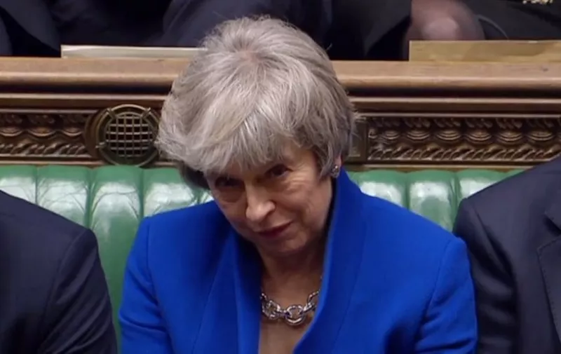 A video grab from footage broadcast by the UK Parliament's Parliamentary Recording Unit (PRU) shows Britain's Prime Minister Theresa May reacting as opposition Labour Party Leader Jeremy Corbyn makes a point of order after the result of the vote on the no confidence motion, in the House of Commons in central London on January 16, 2019. - British Prime Minister Theresa May on Wednesday survived a no-confidence vote sparked by the crushing defeat of her Brexit deal just weeks before the UK leaves the European Union. (Photo by HO / PRU / AFP) / RESTRICTED TO EDITORIAL USE - MANDATORY CREDIT " AFP PHOTO / PRU " - NO USE FOR ENTERTAINMENT, SATIRICAL, MARKETING OR ADVERTISING CAMPAIGNS