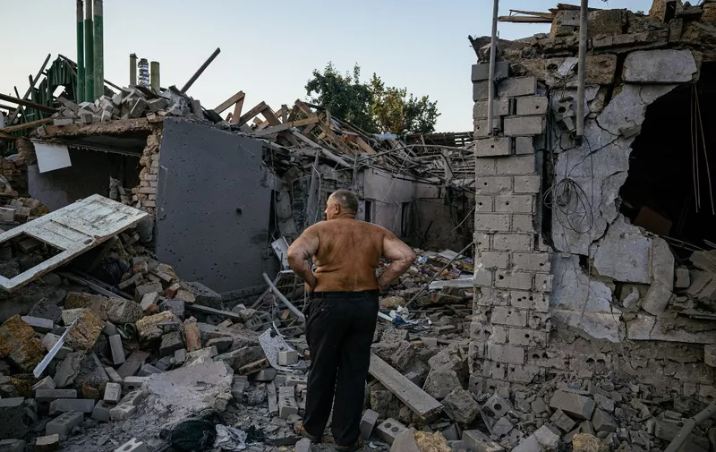 Oleksandr Shulga looks at his destroyed house following a missile strike in Mykolaiv on August 29, 2022, amid the Russian invasion of Ukraine. - Ukrainian forces have begun a counter-attack to retake the southern city of Kherson, which is currently occupied by Russian troops, a local government official said on Monday. (Photo by Dimitar DILKOFF / AFP)