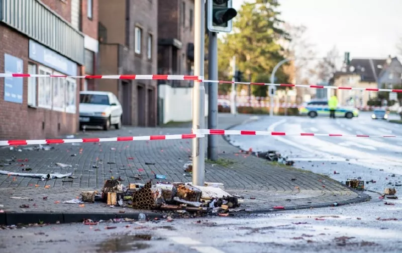 A picture taken on January 1, 2019 in Bottrop shows a cordoned off area at the site where a man injured four people after driving into a group celebrating the new year, in what police described as an anti-migrant attack. - The incident took place a little after midnight in the town of Bottrop, about 12 kilometres (eight miles) north of Essen in Germany's west. The driver first tried to run over a person, but they managed to get out of the way. He then drove into a group setting off fireworks in the street, as many people do when celebrating the new year in Germany. (Photo by Marcel Kusch / dpa / AFP) / Germany OUT