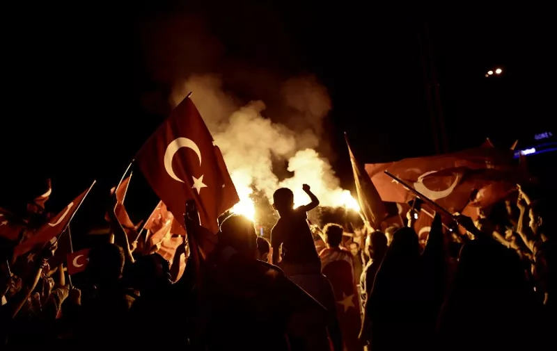 Pro-Erdogan supporters wave Turkish national flags during a rally at Taksim square in Istanbul on July 18, 2016 following the military failed coup attempt of July 15.
Turkish security forces on July 18 carried out new raids against suspected plotters of the botched coup against the rule of President Recep Tayyip Erdogan, as international concern grew over the scale of the crackdown. Thousands of pro-Erdogan supporters waving Turkish flags filled the main Kizilay Square in Ankara while similar scenes were seen in Taksim Square in Istanbul, AFP photographers said. / AFP PHOTO / ARIS MESSINIS