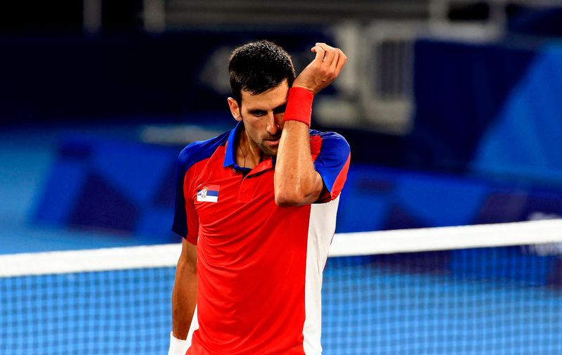 FILE: Novak Djokovic, Serbian professional tennis player and is ranked as world No.1 by ATP, reacts during a quarterfinal match of Tokyo 2020 Olympics against Kei Nishikori at Ariake Tennis Park in Tokyo on July 29, 2021. Australian officials revoked the visa that Novak Djokovic had obtained for entry on 6th. Djokovic arrived in Melbourne, Australia to participate in the Australian Open Tennis Tournament 2022, saying he was granted an exemption from the new coronavirus vaccination. The judge acknowledged Djokovic's allegations and decided to revoke the decision to deny entry. ( The Yomiuri Shimbun via AP Images )