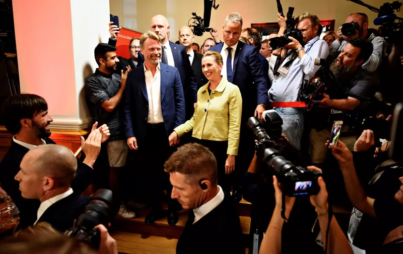 Opposition leader Mette Frederiksen of The Danish Social Democrats (C) walks with supporters after the election results at Christiansborg Castle in Copenhagen early June 6, 2019, during the country's parliamentary elections. - The likely future prime minister of Denmark, Mette Frederiksen, embodies the new Danish Social Democratic model, with a new-found focus on restrictive immigration while championing the welfare state. Frederiksen "has workers' blood in her veins, is a fourth generation Social Democrat... and spent years preparing to take over the leadership (in 2015) of the party she knows so well," daily Politiken wrote just days before Wednesday's general election in which she ultimately emerged victorious. (Photo by Philip Davali / Ritzau Scanpix / AFP) / Denmark OUT