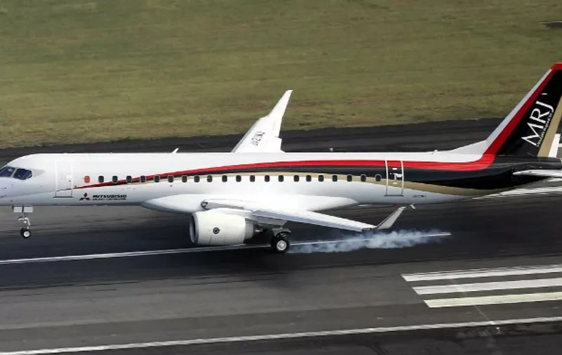 This aerial picture taken on November 11, 2015 shows Japan's first domestically produced passenger jet, the Mitsubishi  Regional Jet (MRJ), arriving at the Nagoya airport in Komaki in Aichi prefecture, central Japan after the first test flight. Japan's first domestic passenger jet successfully took off on its maiden test flight November 11, culminating a decade of development for a programme aimed at competing with Brazilian and Canadian rivals in the global market for smaller aircraft.   AFP PHOTO / JAPAN POOL via JIJI PRESS    JAPAN OUT