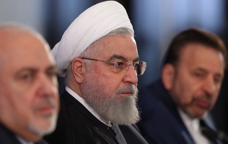 A handout picture provided by the Iranian presidency shows President Hassan Rouhani (C) seated between his top diplomat, Mohammad Javad Zarif (L), and deputy foreign minister, Abbas Araghchi (R), during a meeting at the foreign ministry in Tehran on August 6, 2019. - Rouhani said after the meeting that Tehran favours talks with Washington but the United States must first lift sanctions it imposed on the Islamic republic. (Photo by HO / Iranian Presidency / AFP) / === RESTRICTED TO EDITORIAL USE - MANDATORY CREDIT "AFP PHOTO / HO / IRANIAN PRESIDENCY" - NO MARKETING NO ADVERTISING CAMPAIGNS - DISTRIBUTED AS A SERVICE TO CLIENTS ===