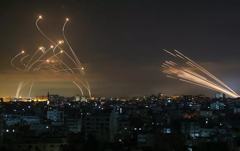 Rockets are seen in the night sky fired towards Israel from Beit Lahia in the northern Gaza Strip on May 14, 2021. - Israel bombarded Gaza with artillery and air strikes on Friday, May 14, in response to a new barrage of rocket fire from the Hamas-run enclave, but stopped short of a ground offensive in the conflict that has now claimed more than 100 Palestinian lives.
As the violence intensified, Israel said it was carrying out an attack "in the Gaza Strip" although it later clarified there were no boots on the ground. (Photo by ANAS BABA / AFP)