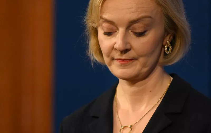 Britain's Prime Minister Liz Truss looks down during a press conference in the Downing Street Briefing Room in central London on October 14, 2022, following the sacking of the finance minister in response to a budget that sparked markets chaos. - Truss dismissed her finance minister, forcing Kwasi Kwarteng to carry the can for turmoil sparked by her right-wing economic platform as restive Conservatives plotted her own demise. (Photo by Daniel LEAL / POOL / AFP)