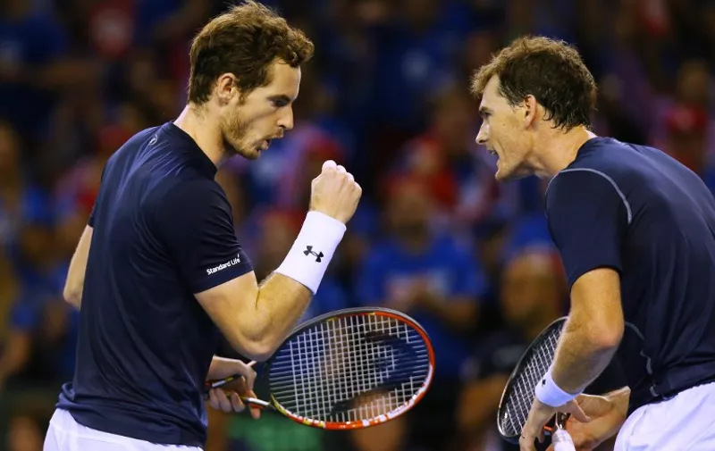 Britain's Andy Murray (L) and Jamie Murray celebrate winning a point in the Davis Cup Doubles match between against Lleyton Hewitt and Sam Groth of Australia in Glasgow, Scotland on September 19, 2015. Andy and Jamie Murray moved Great Britain to the verge of a first Davis Cup final since 1978 after defeating Australia's Lleyton Hewitt and Sam Groth in an epic doubles clash in their semi-final on Saturday. AFP PHOTO / IAN MACNICOL