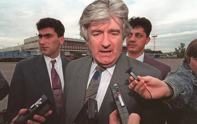 (FILES) Picture dated 13 June 1994 shows Bosnian Serb leader Radovan Karadzic flanked by bodyguards arriving for a private visit at Moscow airport. (Photo by MICHAEL EVSTAFIEV / AFP FILES / AFP)