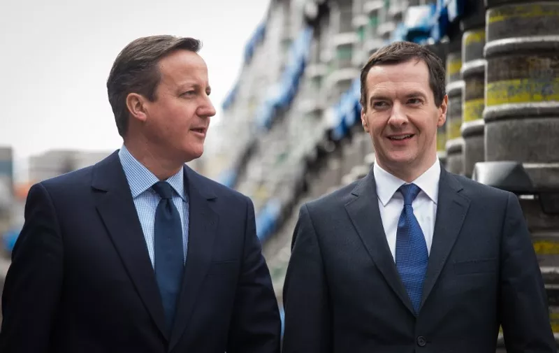 British Prime Minister and Conservative party leader David Cameron (R) and British Finance Minister George Osborne visit the Marston's Brewery in Wolverhampton, central England on April 1, 2015. The visit was part of the Conservative Party's campaign, in the run-up to the general election on May 7, 2015. AFP PHOTO / LEON NEAL / POOL