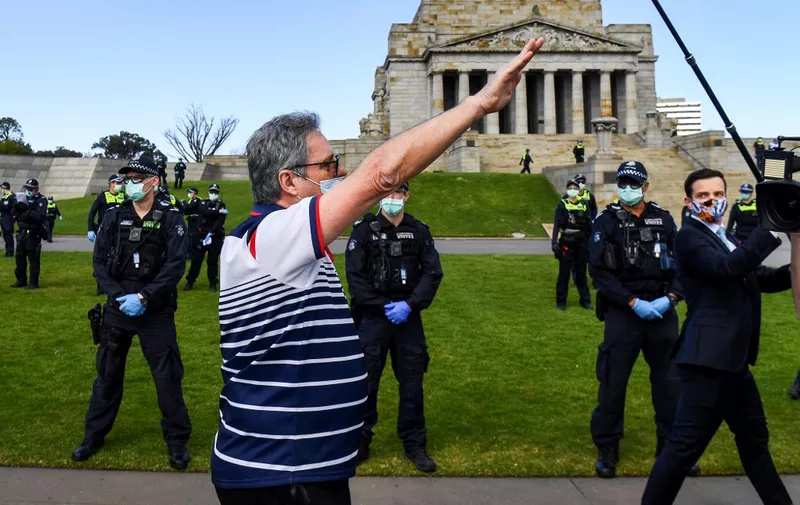A protester performs a Nazi salute at the Shrine of Remembrance in Melbourne on September 5, 2020 during an anti-lockdown rally protesting the state's strict lockdown laws as a preventive measure against the COVID-19 coronavirus. (Photo by William WEST / AFP)