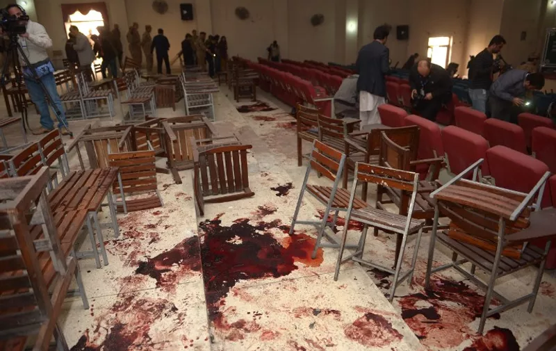 (FILES) In this photograph taken on December 17, 2014, a Pakistani cameraman shoots video of the bloodied floor in the ceremony hall at an army-run school a day after an attack by Taliban militants in Peshawar. Pakistan has on December 2, 2015,  executed four men linked to a Taliban massacre in which more than 130 schoolchildren were killed, with parents of victims saying the convicts deserved "no forgiveness" as the anniversary of the attack approached. The executions, carried out by hanging at a prison in the city of Kohat, officials said, were the first in connection with the December 16, attack on an army-run school in the northwestern city of Peshawar.  AFP PHOTO/FAROOQ NAEEM/FILES / AFP / FAROOQ NAEEM