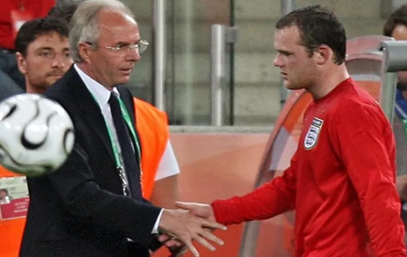 English forward Wayne Rooney is congratulated by Swedish head coach of the English team Sven-Goran Eriksson (L) as he leaves the pitch after being substituted by midfielder Steven Gerrard during the opening round Group B World Cup football match Sweden vs. England, 20 June 2006 in Cologne, Germany. The final score is 2 to 2.        AFP PHOTO / TOSHIFUMI KITAMURA / AFP / TOSHIFUMI KITAMURA
