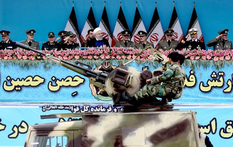 Iranian President Hassan Rouhani (6th-L) attends a military parade surrounded by officers during a ceremony marking the country's annual army day in Tehran, on April 18, 2019. - Iran's President Hassan Rouhani called on Middle East states on April 18 to "drive back Zionism", in an Army Day tirade against the Islamic republic's archfoe Israel. Speaking flanked by top general as troops paraded in a show of might, Rouhani also sought to reassure the region that the weaponry on display was for defensive purposes and not a threat. (Photo by - / AFP)