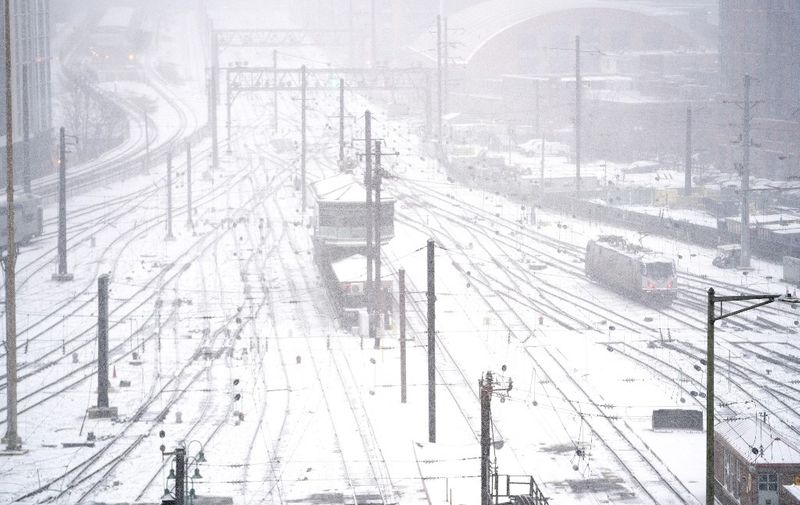 An Amtrak train engine moves along tracks in the train yard at Union Station in Washington, DC, during a winter storm on January 16, 2022. - Millions of Americans were braced for heavy snow and freezing rain Sunday as a major winter storm closed in on the eastern United States, knocking power out to an estimated 200,000 people and counting. The "strong storm over the Southeast/Southern Appalachians will move northeastward inland from the coast to Southeastern Canada by Tuesday," the National Weather Service said on its website. (Photo by Stefani Reynolds / AFP)