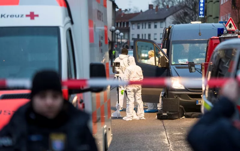 Forensic police work near a crime scene in front of a bar at the Heumarkt in the centre of Hanau, near Frankfurt am Main, western Germany, on February 20, 2020, after at least nine people were killed in two shootings late on February 19. - At least nine people were killed in shootings targeting shisha bars in Germany that sparked a huge manhunt overnight before the suspected gunman was found dead in his home early on February 20. The attacks occurred at two bars in Hanau, about 20 kilometres (12 miles) from Frankfurt, where armed police quickly fanned out and police helicopters roamed the sky looking for those responsible for the bloodshed. Police in the central state of Hesse said the likely perpetrator had been found at his home in Hanau after they located a getaway vehicle seen by witnesses. Another body was also discovered at the property. German counter-terror prosecutors said on February 20 they had taken over the investigation into two linked shootings. (Photo by Thomas Lohnes / AFP)