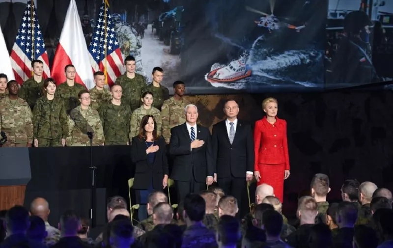 US Vice President Mike Pence (2L), his wife Karen Pence (L), Poland's President Andrzej Duda (2R) and his wife Agata Kornhauser-Duda attend a ceremony at the 1st Airlift Base in Warsaw, on February 13, 2019 during a three-day visit of the US Vice President to Poland. (Photo by Janek SKARZYNSKI / AFP)