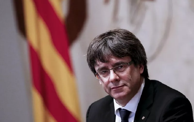 Catalan regional government president Carles Puigdemont attends a regional government meeting at the Generalitat Palace in Barcelona on October 10, 2017. 
Spain's worst political crisis in a generation will come to a head as Catalonia's leader could declare independence from Madrid in a move likely to send shockwaves through Europe.  / AFP PHOTO / PAU BARRENA