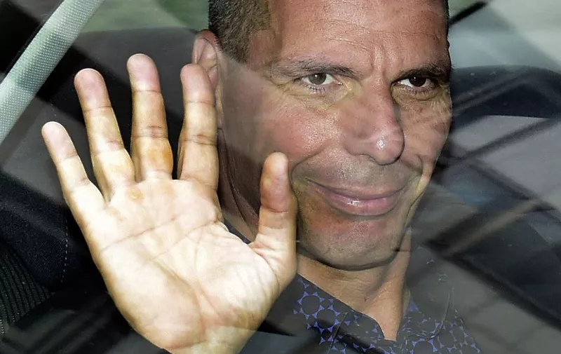 A picture taken on May 8, 2015 shows Greek Finance Minister Yanis Varoufakis waving as he leaves Spain's ministry of economy and competitiveness after a meeting in Madrid. Varoufakis said he was resigning on July 6, 2015, in a shock announcement despite the government having secured a resounding victory for the 'No' vote in the country's referendum on bailout conditions.  AFP PHOTO/ GERARD JULIEN