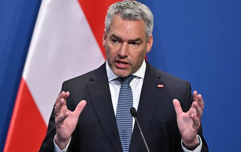Austrian Chancellor Karl Nehammer attends a press conference with the Serbian President and the Hungarian Prime Minister in Budapest on October 03, 2022 after their meeting on the margins of an immigration summit. (Photo by ATTILA KISBENEDEK / AFP)