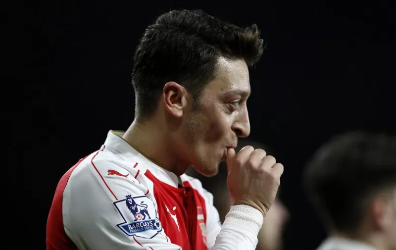 Arsenal's German midfielder Mesut Ozil celebrates after scoring their second goal during the English Premier League football match between Arsenal and Bournemouth at the Emirates Stadium in London on December 28, 2015. / AFP / ADRIAN DENNIS
