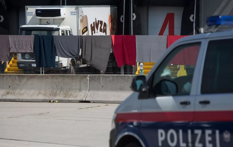 A refrigerated truck, in which bodies of 71 migrants have been found on the A 4 Austrian highway, is parked in a facility which used to be a veterinary station at the border in Nickelsdorf, Austria on August 28, 2015. Austrian police said Friday that three people were in custody in Hungary over the discovery of 71 dead migrants in an abandoned truck with Hungarian number plates.  AFP PHOTO / VLADIMIR SIMICEK